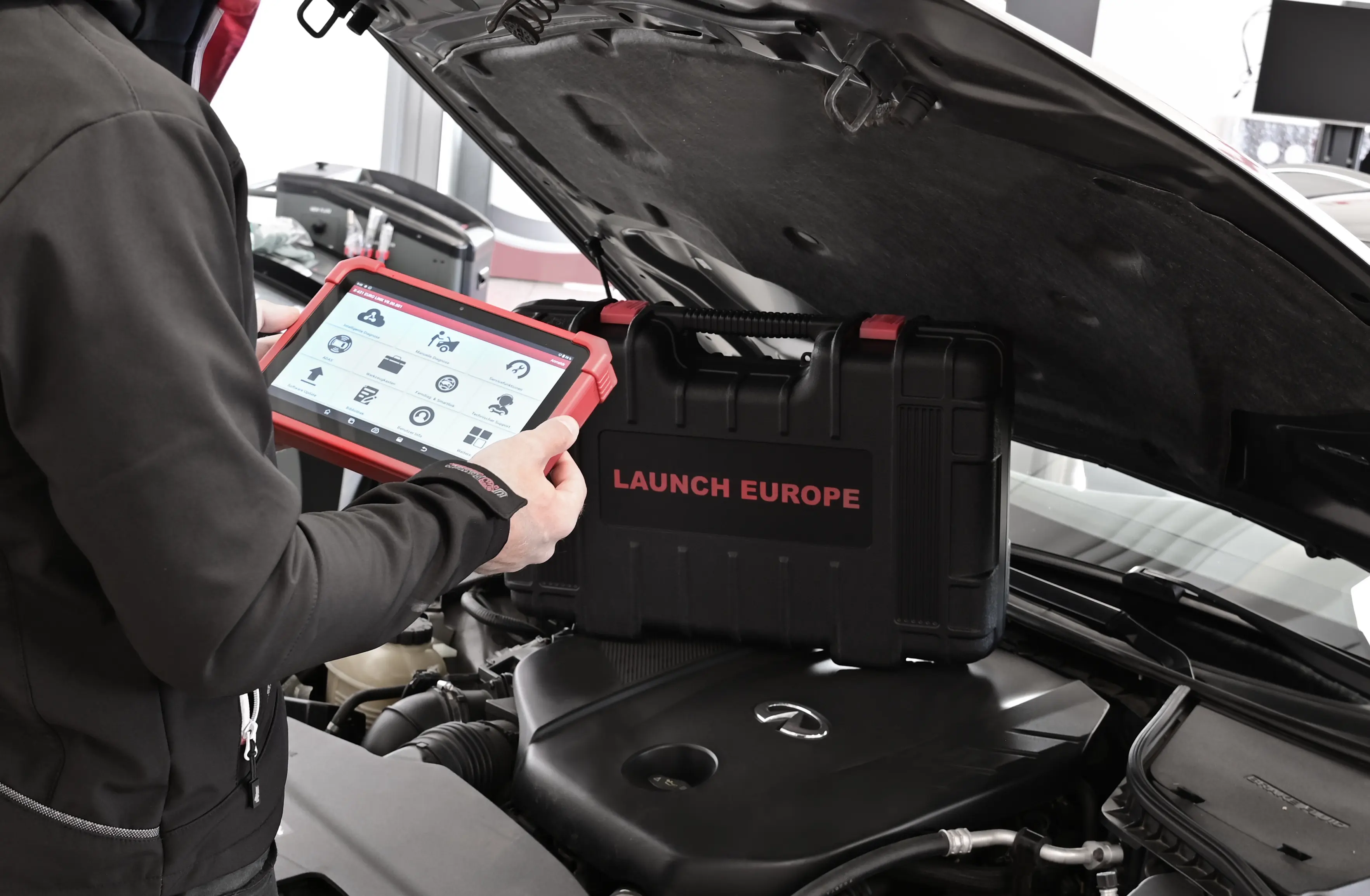 Technician using a diagnostic scan tool to identify a fault code on a vehicle.