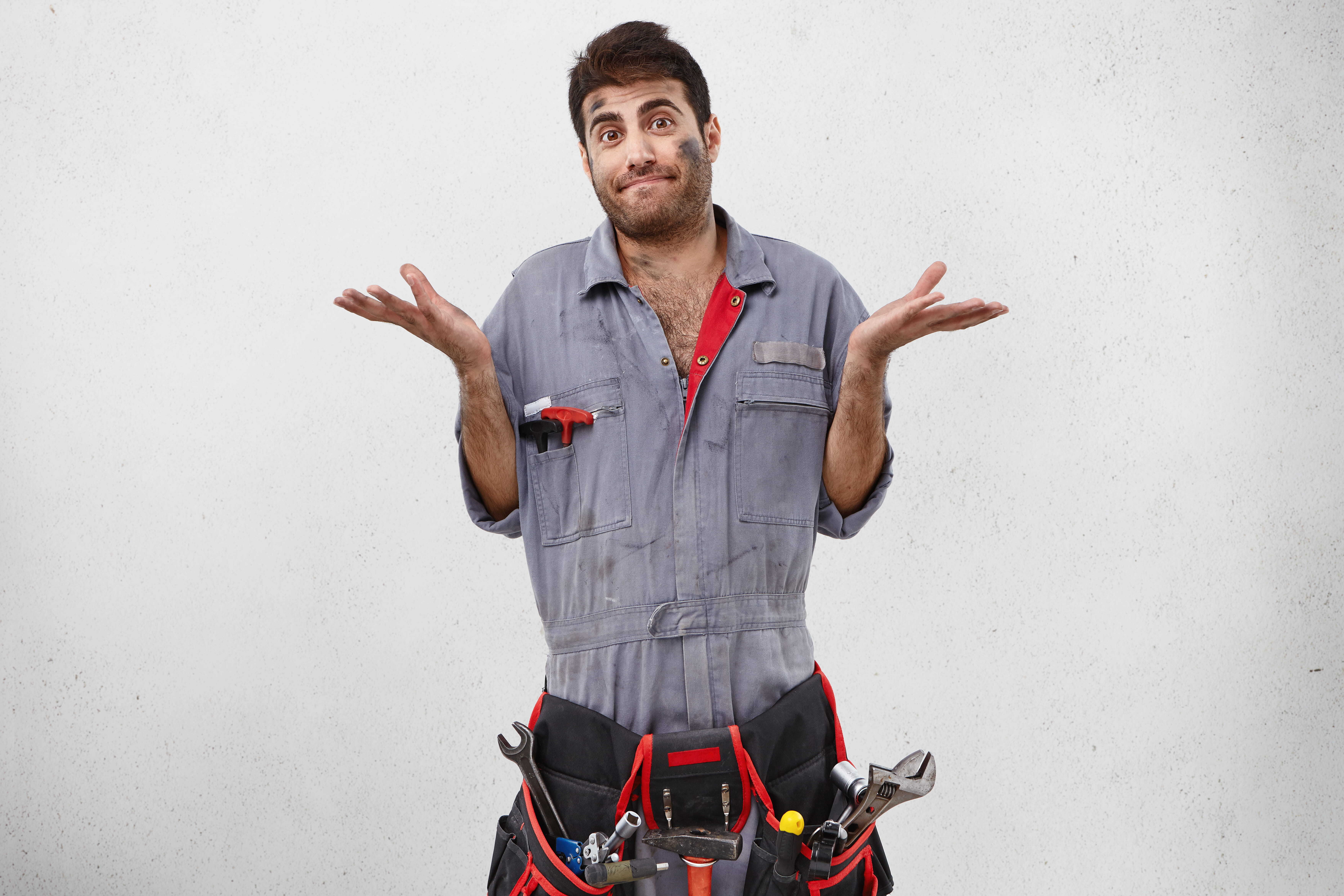 Mechanic stood with his arms raised wearing a tool belt with launch x431 parts